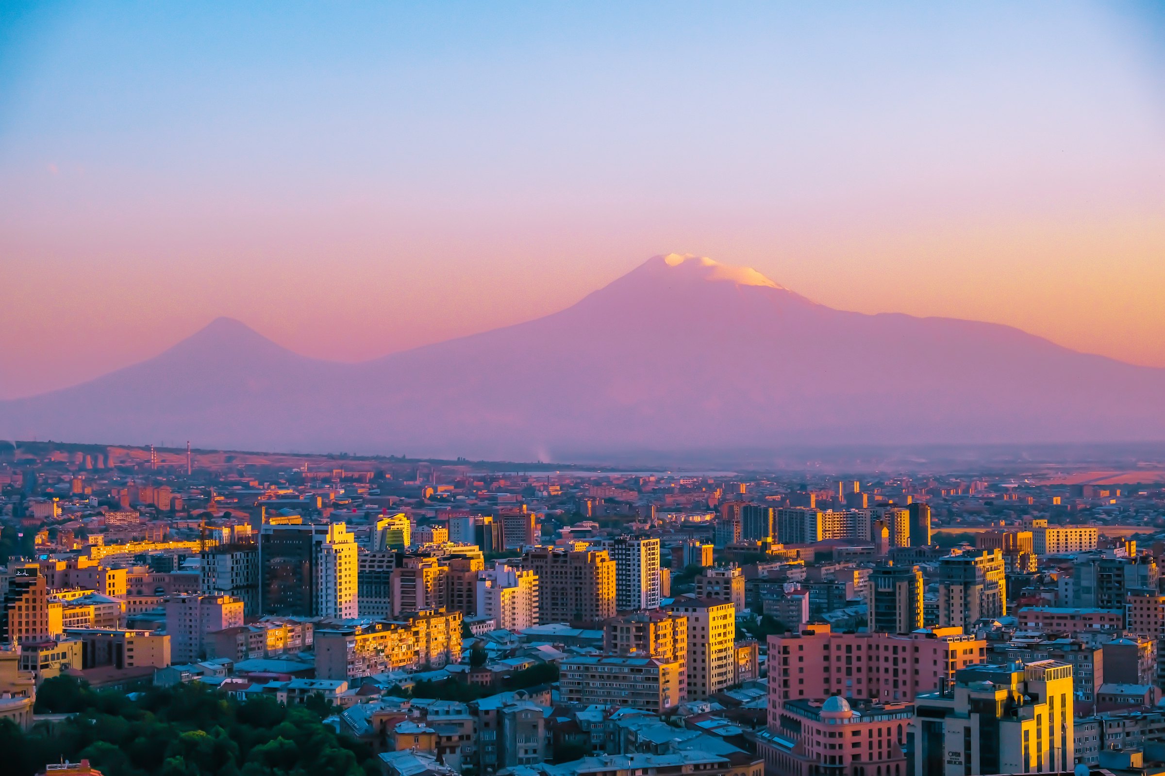 Mount Ararat rising over the Yerevan skyline at sunset